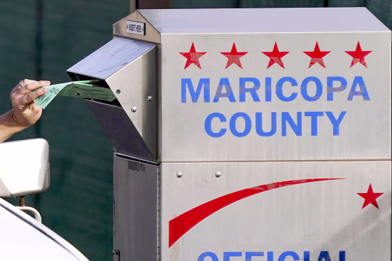 A voter casts their ballot at a secure ballot drop box at the Maricopa County Tabulation and Election Center in Phoenix, Tuesday, Nov. 1, 2022.