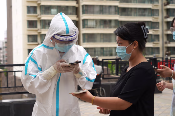 LANZHOU, CHINA - JULY 12: A medical worker registers personal information of a resident at a COVID-19 nucleic testing site on July 12, 2022 in Lanzhou, Gansu Province of China. (Photo by VCG/VCG via Getty Images)