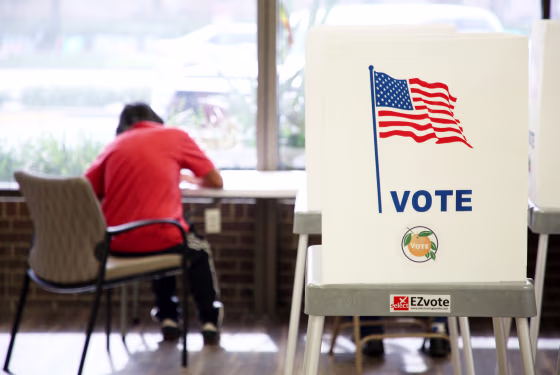 A voter casts their ballot at the Orange County Supervisor of Elections headquarters