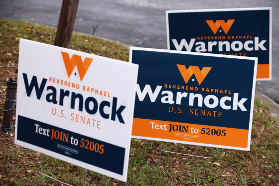 Campaign signs for Sen. Raphael Warnock