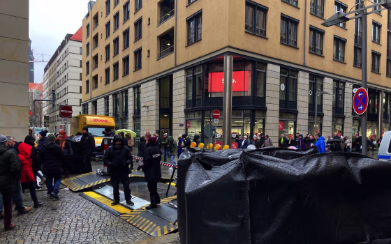 People gather near the Altmarktgalerie after a hostage situation in Dresden, Germany