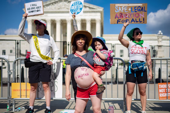 Abortion rights demonstrator Amanda Herring and her one-year-old son Abraham Herring join in protests outside the United States Supreme Court in Washington