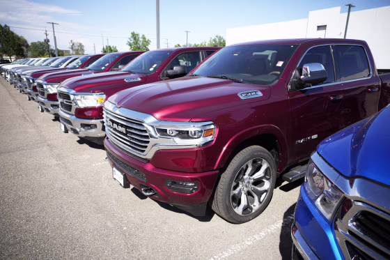 Ram 1500 pickup trucks parked in a storage lot at a Ram dealership