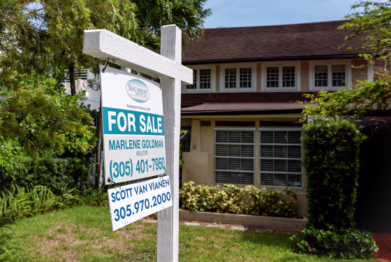 A 'for sale' sign hangs in front of a home on June 21, 2022 in Miami.