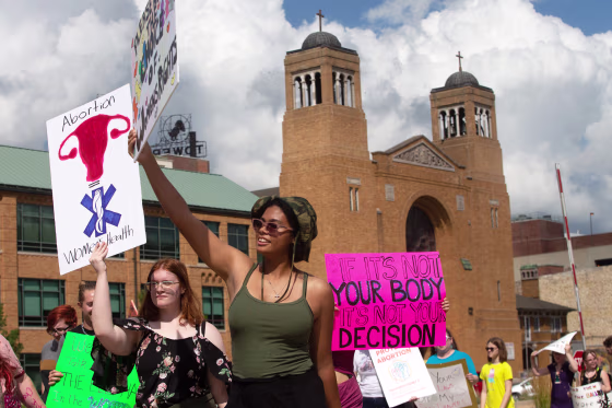 Abortion rights supporters took their messages with them as over a hundred marched around the Kansas Statehouse following a rally Saturday afternoon.