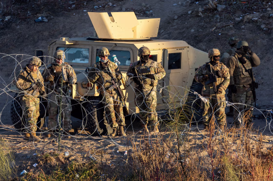 Texas National Guard troops block migrants from entering a popular crossing area along the bank of the Rio Grande in El Paso, Texas after laying down concertina wire on December 20, 2022 as viewed from Ciudad Juarez, Mexico. Texas Governor Greg Abbott ordered 400 troops to the U.S.-Mexico border in El Paso, which is under a state of emergency due to a surge of migrants crossing from Mexico into the city. U.S. Supreme Court Chief Justice John Roberts issued an "administrative stay," temporarily leaving in place the Title 42 pandemic era policy to quickly expel migrants at the border. Border officials expect an even larger migrant surge at the border if and when Title 42 is lifted