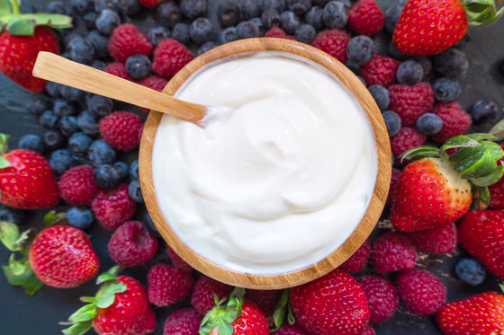 Greek yogurt in a glass jars with spoons,Healthy breakfast with Fresh greek yogurt, muesli and berries on background
