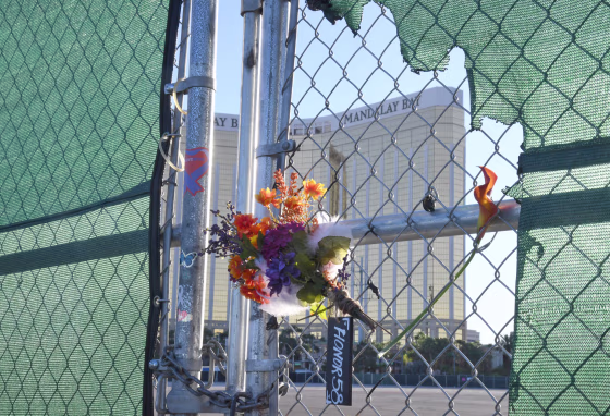 Flowers and a sign reading "HONOR 58" hang on a fence outside the Las Vegas Village across from Mandalay Bay Resort and Casino on Sept. 30, 2019 in Las Vegas.