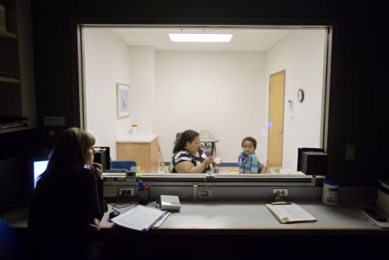 Clinical specialist Catey Funaiock, left, observes as Marlaina Dreher and her son, Brandon, take part in the pediatric feeding disorder program at the Marcus Autism Center