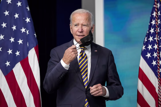President Joe Biden removes his mask before speaking about the coronavirus pandemic in Washington on Oct. 14, 2021.