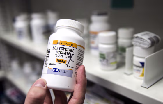 A pharmacist holds a bottle of the antibiotic doxycycline hyclate in Sacramento, Calif., on July 8, 2016.