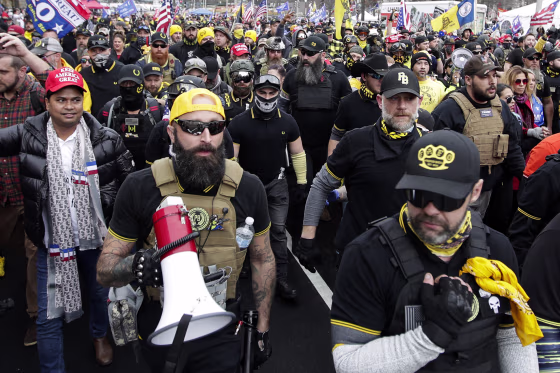 FILE - Proud Boys member Jeremy Joseph Bertino, second from left, joins other supporters of President Donald Trump who are wearing attire associated with the Proud Boys as they attend a rally at Freedom Plaza, Dec. 12, 2020, in Washington. Bertino told jurors on Tuesday, Feb. 21, 2023, that he viewed their far-right extremist organization as "the tip of the spear" after the 2020 election. Bertino is testifying against former Proud Boys national leader Enrique Tarrio and four lieutenants as part of a cooperation deal with federal prosecutors.