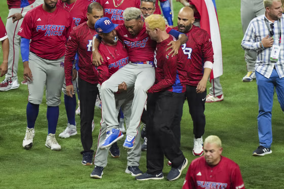 Edwin Diaz of Puerto Rico is helped off the field after being injured during the on-field celebration after defeating the Dominican Republic during the World Baseball Classic Pool D on March 15, 2023, in Miami.