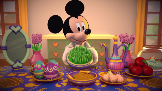 Mickey Mouse displaying his “haftseen,” a traditional table put together for the Persian New Year