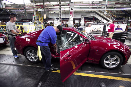 Workers put the finishing touches on a new General Motors 2016 Chevrolet Camaro as it rolls off the production line at GM's Lansing Grand River Assembly Plant October 26, 2015 in Lansing, Michigan. The Gen Six Camaro is the first to be produced in the United States since the third generation Camaro in 1992.
