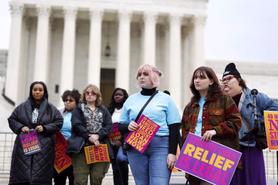 Student loan borrowers gather at the Supreme Court the evening before the court hears two cases on student loan relief on Feb. 27, 2023.