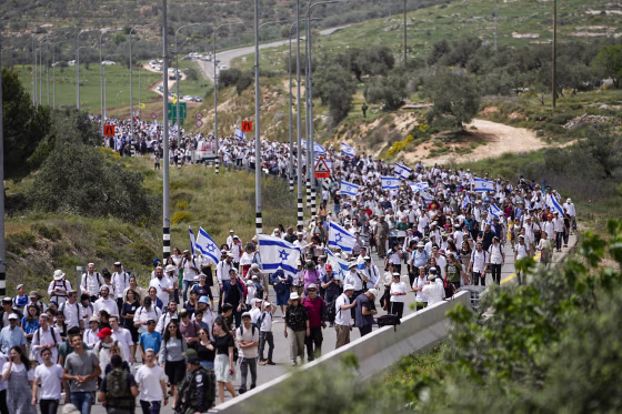People march to Eviatar in the occupied West Bank territory on April 10, 2023.