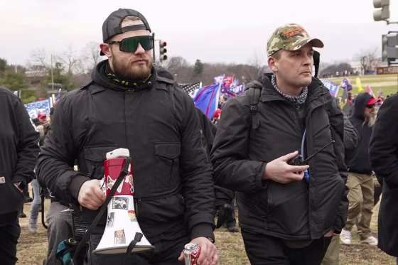 Proud Boys members Ethan Nordean, left, and Zachary Rehl walk toward the U.S. Capitol