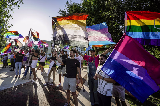 Image: Protesters wave pride flags as the join others, including immigrants rights and abortion rights groups and members of the LGBTQ community from across the state in a rally and march on May 1, 2023, in Orlando, Fla.