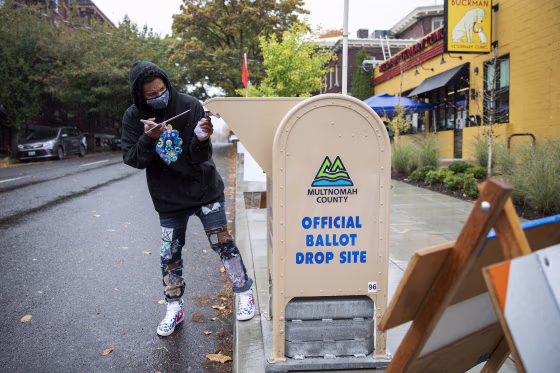 Matthew Parker-Hicks drops off his ballot outside the Multnomah County elections office on Election Day in Portland, Ore., on Nov. 3, 2020. Parker-Hicks turned 18 just past the last presidential election in 2016, and said he was excited to be able to vote for the first time this year. "I feel like I'm part of the ecosystem now," he said. (Alisha Jucevic / for NBC News)