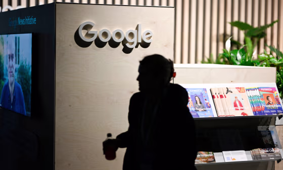 A woman passes by the Google booth at the re:publica 2022 digital media convention in Berlin.