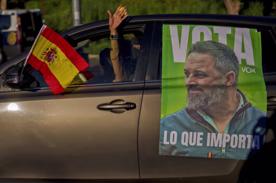 A woman drives her car with a picture of the VOX far-right party leader Santiago Abascal before an election campaign event in Guadalajara, Spain, on July 15, 2023.
