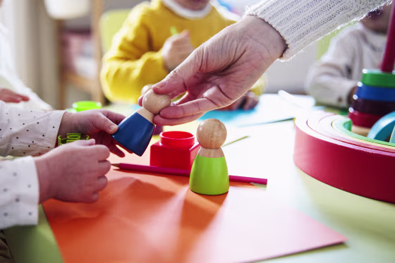 Preschool children playing with colorful shapes