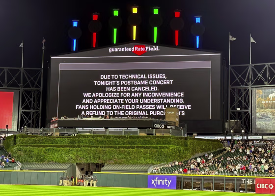 A message on the main scoreboard at Guaranteed Rate Field announces the cancellation of a '90s concert that was to feature Vanilla Ice, Tone Loc and Rob Base after a baseball game between the Chicago White Sox and the Oakland Athletics, Friday, Aug. 25, 2023, in Chicago.
