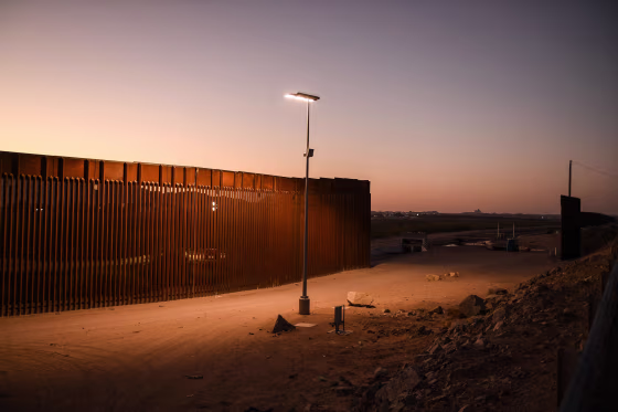 A gap in the border wall is illuminated at night between the U.S. and Mexico in Yuma, Ariz., on May 31, 2022.