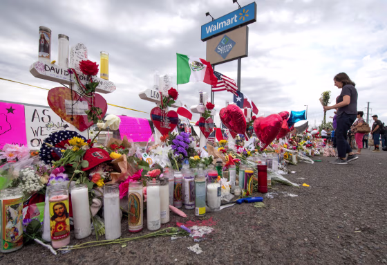 People leave flowers at a makeshift memorial for shooting victims at the Cielo Vista Mall Walmart, in El Paso, Texas