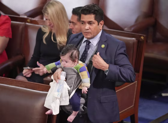 Rep. Jimmy Gomez, D-Calif., carries his infant son Hodge on the chamber floor on Jan. 5, 2023.