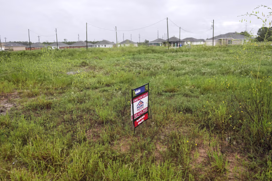 A "For Sale" sign on a vacant lot in the Santa Fe subdivision of the Colony Ridge development in Cleveland, Texas.