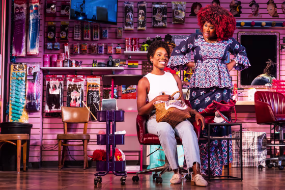 Rachel Christopher as “Jennifer” and Zenzi Williams as “Bea” in “Jaja’s African Hair Braiding.”