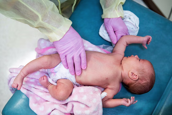 A doctor examines a baby with respiratory symptoms in Cloquet, Minn., in 2020.