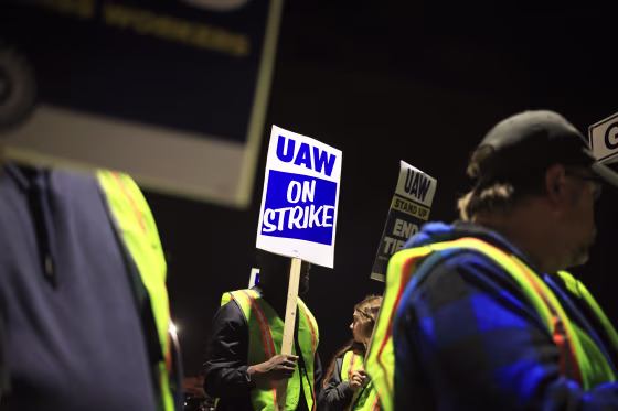Factory workers and UAW union members picket outside the Ford Motor Co. Kentucky Truck Plant