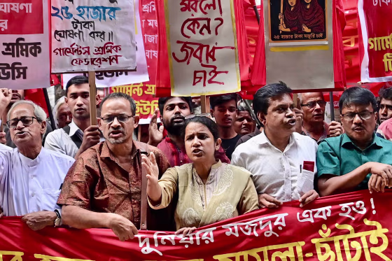 Police fired tear gas at thousands of workers who set a bus on fire outside Bangladesh's capital on November 7, with tensions are rising ahead of a new minimum wage announcement for millions of garment labourers.