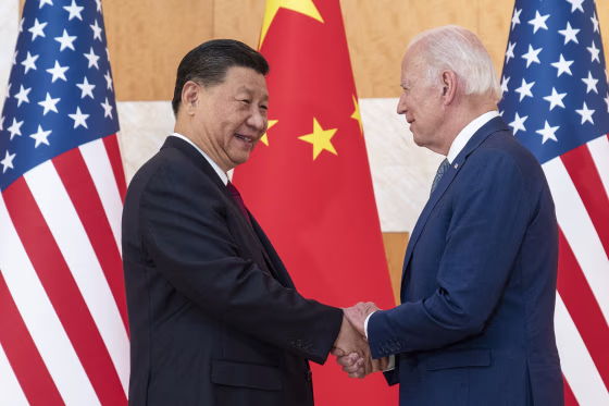 Xi Jinping and Joe Biden shake hands.