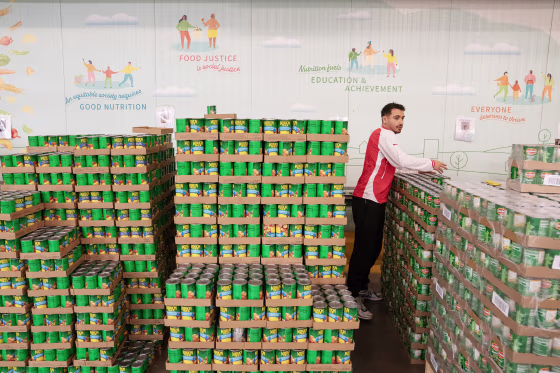 A volunteer assembles boxes of food at the Capital Area Food Bank