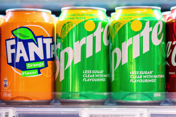Cans of Sprite and Fanta, both produced by the Coca-Cola Company.