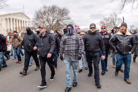 Charles Donohoe, right, with Proud Boys and Trump supporters walk in front of the Capitol on Jan. 6, 2021.