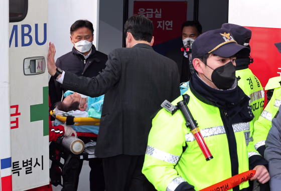 South Korean opposition party leader Lee Jae-myung, who was attacked in Busan, lies on a stretcher as he arrives at Seoul National University Hospital in Seoul on Jan. 2, 2024.