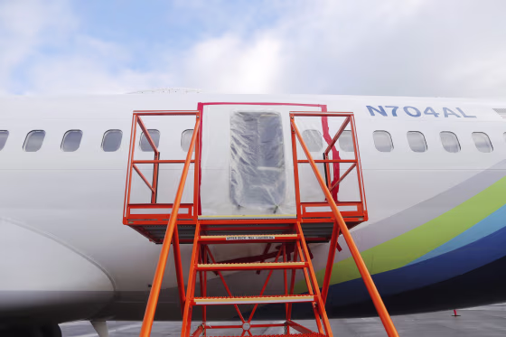 Plastic covers the hole where the door plug had been on Alaska Airlines Flight 1282.