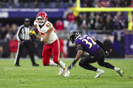 Travis Kelce runs the ball during the AFC Championship NFL football game against the Baltimore Ravens at M&T Bank Stadium on January 28, 2024.