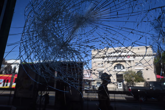 A shattered window of a convenience store along H Street NE on Oct. 30, 2023 in Washington, DC.