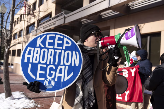 Abortion activists demonstrate outside of the Democratic National Committee