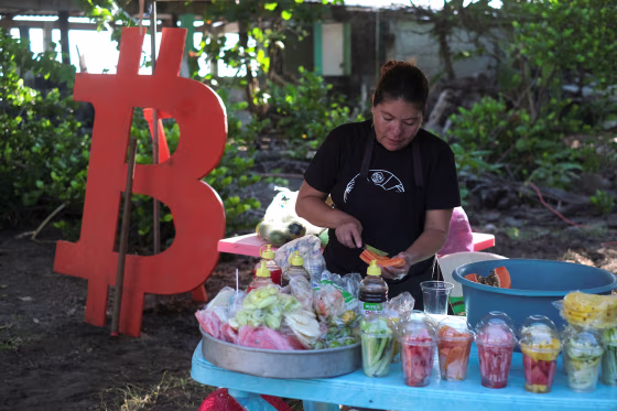 A woman sells fruit in a market during a Bitcoin summit, in Chiltiupan, El Salvador