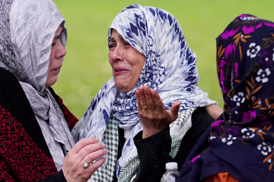 Mourners cry