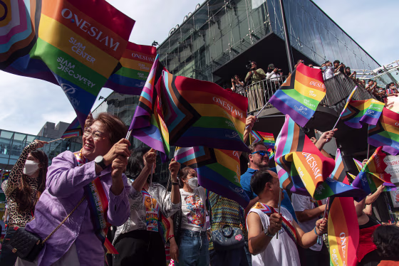 Participants seen waving rainbow flags during the Bangkok