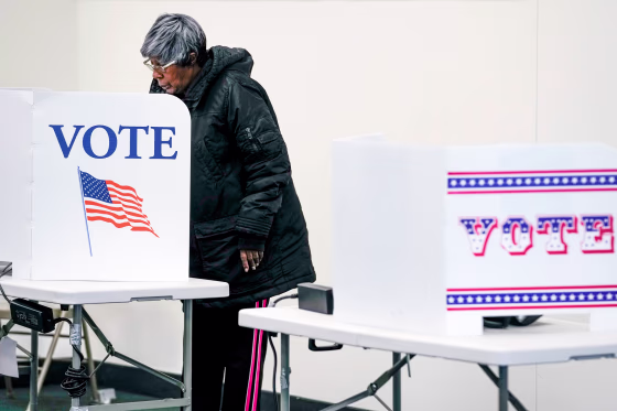 A voter casts an early ballot at a polling station