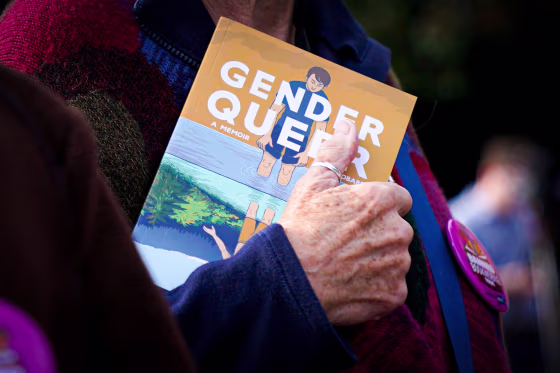 A person holds the Gender Queer memoir.